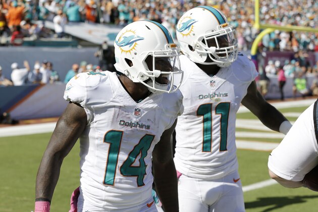 Miami Dolphins wide receiver Mike Wallace (11) congratulates Miami Dolphins wide receiver Jarvis Landry (14) during the second half of an NFL football game against the Green Bay Packers, Sunday, Oct. 12, 2014, in Miami Gardens, Fla. The Packers defeat the Dolphins 27-24. (AP Photo/Wilfredo Lee)