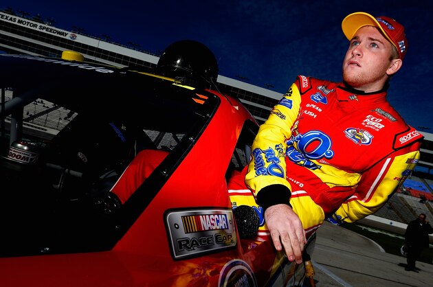 FORT WORTH, TX - NOVEMBER 01:  Chris Buescher, driver of the #60 Bit O Honey Ford, climbs into his car in the garage area during Pinnacle Propane Qualifying for the NASCAR Nationwide Series O'Reilly Auto Parts Challenge at Texas Motor Speedway on November 1, 2014 in Fort Worth, Texas.  (Photo by Sean Gardner/Getty Images for Texas Motor Speedway)