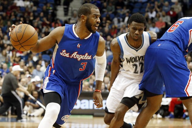 Los Angeles Clippers’ Chris Paul drives as teammate DeAndre Jordan, right, sets a pick on Minnesota Timberwolves’ Andrew Wiggins during the second half of an NBA basketball game, Monday, March 2, 2015, in Minneapolis. The Clippers won 110-105. (AP Photo/Jim Mone)