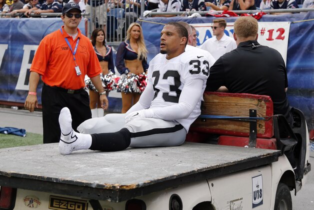 Oakland Raiders strong safety Tyvon Branch is taken off the field on a cart in the second half of an NFL football game against the New England Patriots Sunday, Sept. 21, 2014, in Foxborough, Mass. (AP Photo/Elise Amendola)