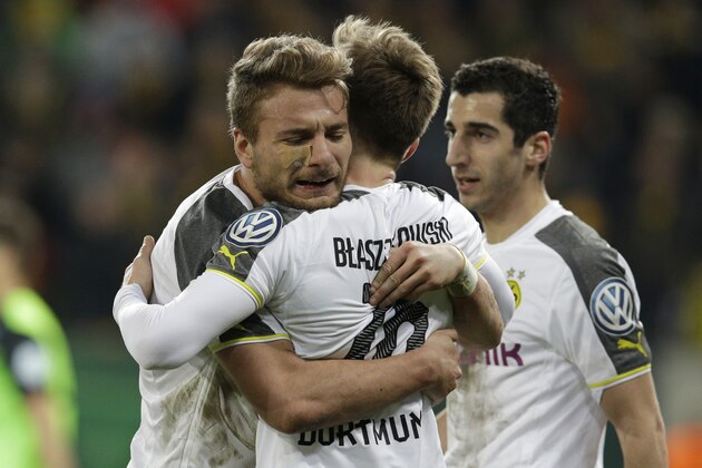 Dortmund's Ciro Immobile from Italy, left, celebrates after scoring his side's 2nd goal during the German soccer cup round of sixteen match between third division team Dynamo Dresden and first division team Borussia Dortmund in Dresden, Germany, Tuesday, March 3, 2015. (AP Photo/Michael Sohn)
