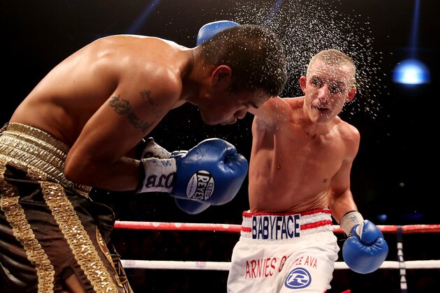 LIVERPOOL, ENGLAND - DECEMBER 07:  Paul Butler (R) catches Ruben Montoya during their WBO and Vacant WBA Intercontinental Super Flyweight Championship bout at Liverpool Echo Arena on December 7, 2013 in Liverpool, England.  (Photo by Scott Heavey/Getty Images)