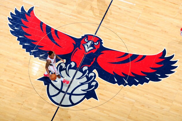ATLANTA, GA - NOVEMBER 26:  Jeff Teague #0 of the Atlanta Hawks takes the ball up court across the Hawks logo during the game against the Orlando Magic on November 26, 2013 at Philips Arena in Atlanta, Georgia.  NOTE TO USER: User expressly acknowledges and agrees that, by downloading and/or using this Photograph, user is consenting to the terms and conditions of the Getty Images License Agreement. Mandatory Copyright Notice: Copyright 2013 NBAE (Photo by Scott Cunningham/NBAE via Getty Images)