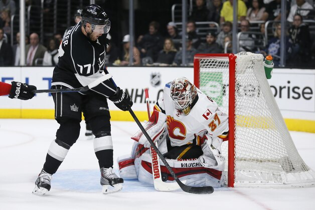 Calgary Flames goalie Joni Ortio makes a save as Los Angeles Kings center Jeff Carter tries to score during the second period of an NHL hockey game, Monday, Jan. 19, 2015, in Los Angeles. (AP Photo/Danny Moloshok)