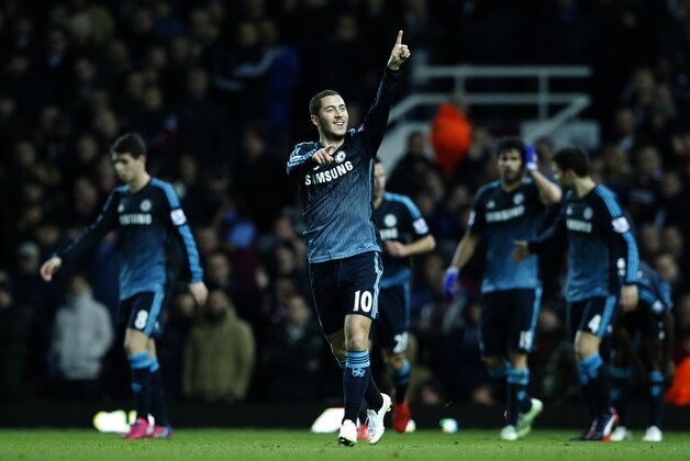 Chelsea's Eden Hazard celebrates after scoring the opening goal of the game during the English Premier League soccer match between West Ham United and Chelsea , at the Boleyn ground in London, Wednesday, March, 4, 2015. (AP Photo/Alastair Grant)