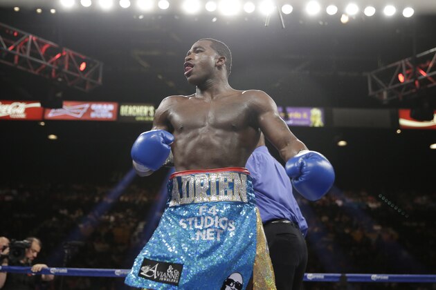 Adrien Broner celebrates his unanimous decision victory over Carlos Molina in their WBA super lightweight title boxing fight Saturday, May 3, 2014, in Las Vegas. (AP Photo/Eric Jamison)