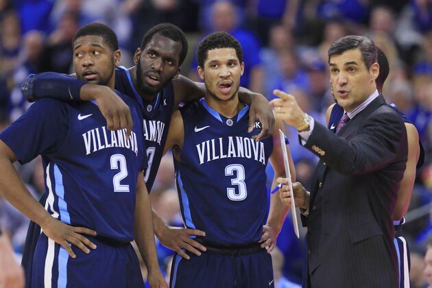 Villanova coach Jay Wright talks to Kris Jenkins (2), Daniel Ochefu and Josh Hart (3) during a timeout in the second half of an NCAA college basketball game against Creighton in Omaha, Neb., Tuesday, March 3, 2015. Villanova won 76-72. (AP Photo/Nati Harnik)