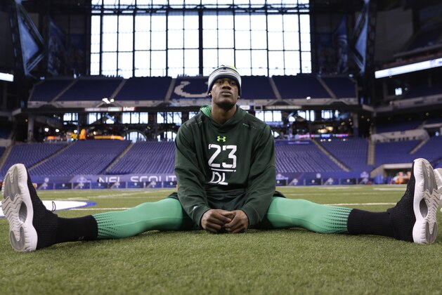 Nebraska defensive lineman Randy Gregory stretches before drills at the NFL football scouting combine in Indianapolis, Sunday, Feb. 22, 2015. (AP Photo/David J. Phillip)