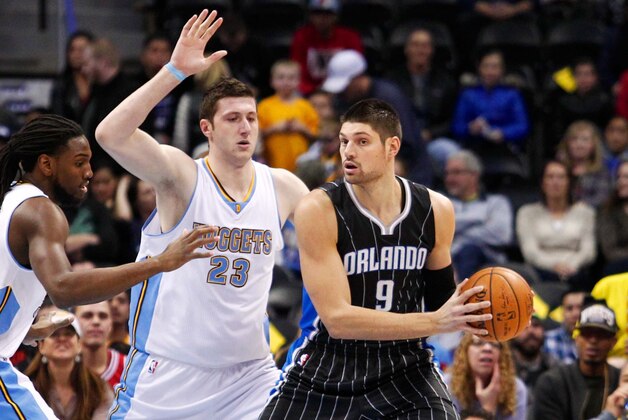 Jan 7, 2015; Denver, CO, USA; Denver Nuggets forward Kenneth Faried (35) and center Jusuf Nurkic (23) guard Orlando Magic center Nikola Vucevic (9) in the first quarter at Pepsi Center. Mandatory Credit: Isaiah J. Downing-USA TODAY Sports