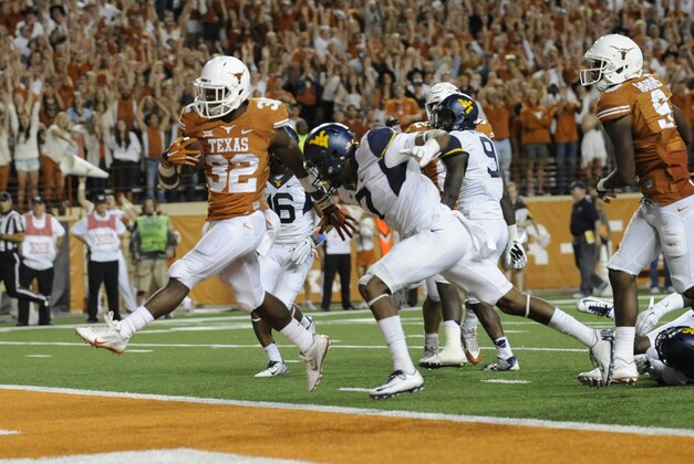 Nov 8, 2014; Austin, TX, USA; Texas Longhorns running back Johnathan Gray (32) runs for a touchdown against the West Virginia Mountaineers during the second half at Darrell K Royal-Texas Memorial Stadium. Texas beat West Virginia 33-16. Mandatory Credit: Brendan Maloney-USA TODAY Sports