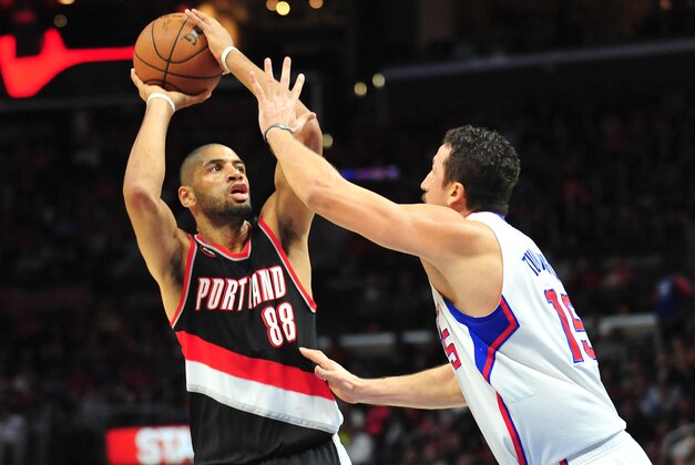 March 4, 2015; Los Angeles, CA, USA; Portland Trail Blazers forward Nicolas Batum (88) shoots against the defense of Los Angeles Clippers forward Hedo Turkoglu (15) during the first half at Staples Center. Mandatory Credit: Gary A. Vasquez-USA TODAY Sports
