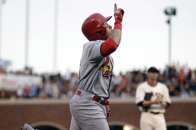 St. Louis Cardinals' Kolten Wong rounds the base after a home run as San Francisco Giants starting pitcher Ryan Vogelsong looks on during the third inning of Game 4 of the National League baseball championship series Wednesday, Oct. 15, 2014, in San Francisco. (AP Photo/Jeff Roberson)