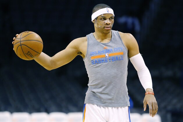 Oklahoma City Thunder guard Russell Westbrook warms up before an NBA basketball game between the Philadelphia 76ers and the Oklahoma City Thunder in Oklahoma City, Wednesday, March 4, 2015. Westbrook is wearing a clear protective mask to shield an injury to his zygomatic arch. (AP Photo/Sue Ogrocki)
