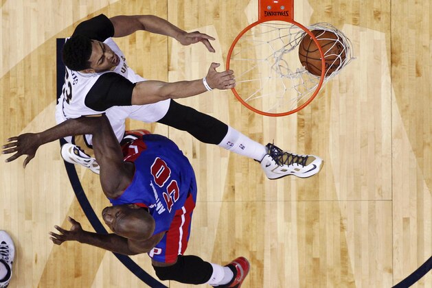 New Orleans Pelicans forward Anthony Davis, top, dunks against Detroit Pistons center Joel Anthony (50) during the first half of an NBA basketball game Wednesday, March 4, 2015, in New Orleans. (AP Photo/Gerald Herbert)