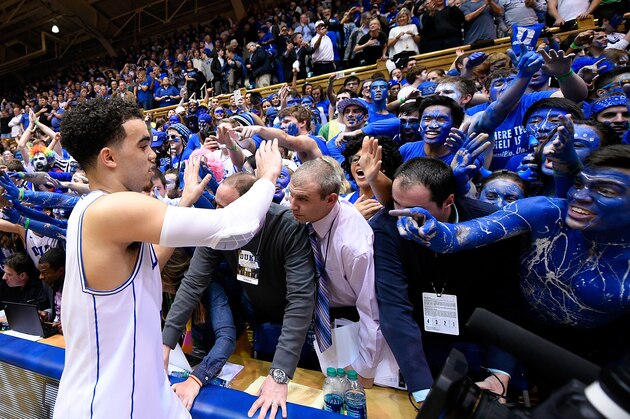 DURHAM, NC - FEBRUARY 18:  Tyus Jones #5 of the Duke Blue Devils celebrates with fans after a win against the North Carolina Tar Heels at Cameron Indoor Stadium on February 18, 2015 in Durham, North Carolina. Duke won 92-90 in overtime.  (Photo by Grant Halverson/Getty Images)
