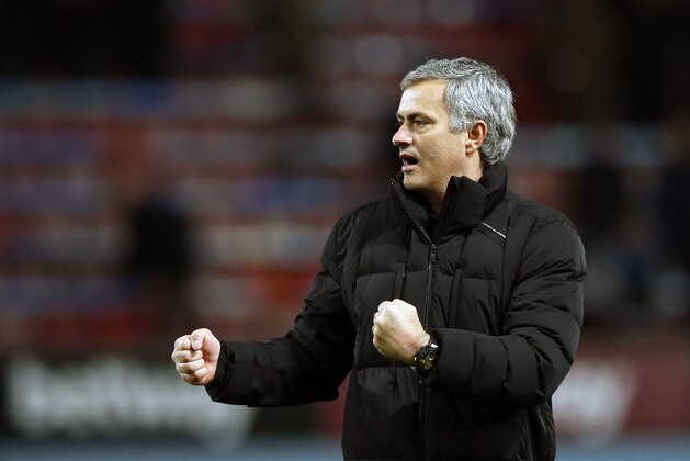 Chelsea's head coach Jose Mourinho celebrates towards his teams fans after the English Premier League soccer match between West Ham United and Chelsea , at the Boleyn ground in London, Wednesday, March, 4, 2015. Chelsea won the game 1-0. (AP Photo/Alastair Grant)
