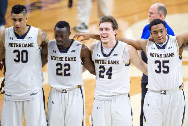 Jan 17, 2015; South Bend, IN, USA; Notre Dame Fighting Irish forward Zach Auguste (30) guard Jerian Grant (22) guard Pat Connaughton (24) and forward Bonzie Colson (35) sing the Notre Dame alma mater after defeating the Miami Hurricanes 75-70 at the Purcell Pavilion. Mandatory Credit: Matt Cashore-USA TODAY Sports