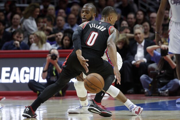 Portland Trail Blazers' Damian Lillard, front, tries to get the ball past Los Angeles Clippers' Chris Paul during the first half of an NBA basketball game Wednesday, March 4, 2015, in Los Angeles. (AP Photo/Jae C. Hong)