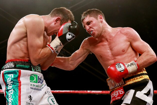 HULL, ENGLAND - JULY 13:  Derry Matthews (L) in action with Tommy Coyle during their Vacant Commonwealth Lightweight Championship bout at Craven Park Stadium on July 13, 2013 in Hull, England.  (Photo by Scott Heavey/Getty Images)