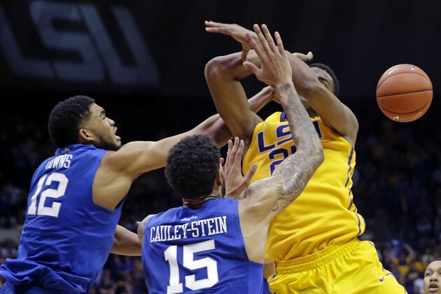 LSU forward Jordan Mickey (25) battles for possession against Kentucky forward Karl-Anthony Towns (12) and forward Willie Cauley-Stein (15) in the second half of an NCAA college basketball game in Baton Rouge, La., Tuesday, Feb. 10, 2015.  Kentucky won 71-69. (AP Photo/Gerald Herbert)