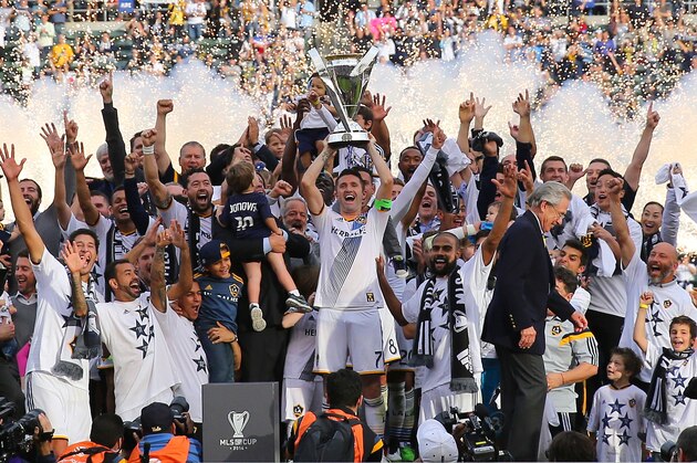 LOS ANGELES, CA - DECEMBER 07:  Captain Robbie Keane #7 of the Los Angeles Galaxy celebrates on the hoists over his head the Philip F. Anschutz Trophy after the Galaxy defeated the New England Revolution 2-1 in the 2014 MLS Cup at StubHub Center on December 7, 2014 in Los Angeles, California.  (Photo by Victor Decolongon/Getty Images)