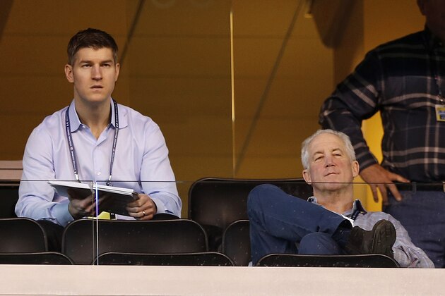 Chicago Bears head coach John Fox, right, sits with general manager Ryan Pace as they watch the NFL football scouting combine in Indianapolis, Friday, Feb. 20, 2015. (AP Photo/Julio Cortez)