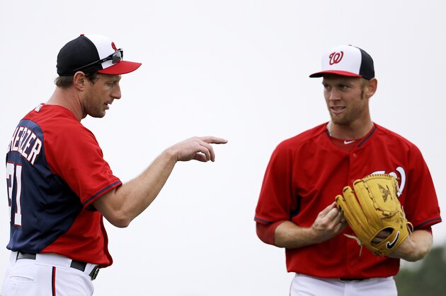 Washington Nationals pitcher Max Scherzer, left, talks with teammate Stephen Strasburg during a spring training baseball workout, Wednesday, Feb. 25, 2015, in Viera, Fla. (AP Photo/David Goldman)