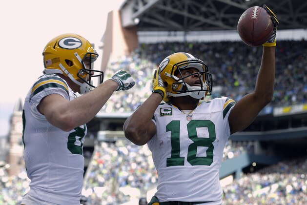 Green Bay Packers' Randall Cobb (18) celebrates his touchdown catch with teammate Jordy Nelson during the first half of the NFL football NFC Championship game against the Seattle Seahawks Sunday, Jan. 18, 2015, in Seattle. (AP Photo/Jeff Chiu)