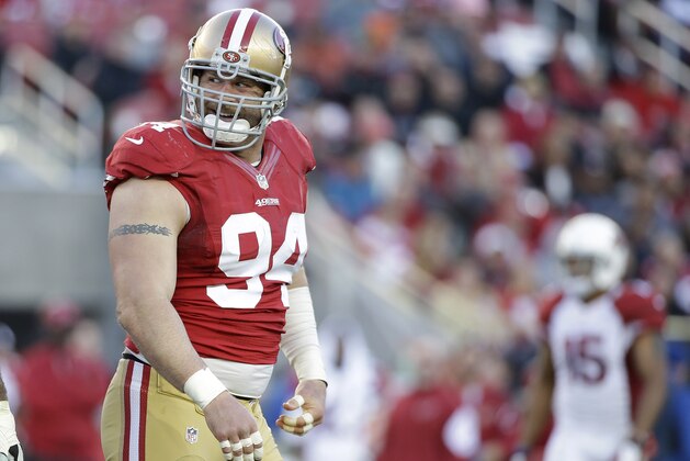 San Francisco 49ers defensive tackle Justin Smith (94) smiles during the second half of an NFL football game against the Arizona Cardinals in Santa Clara, Calif., Sunday, Dec. 28, 2014. (AP Photo/Marcio Jose Sanchez)