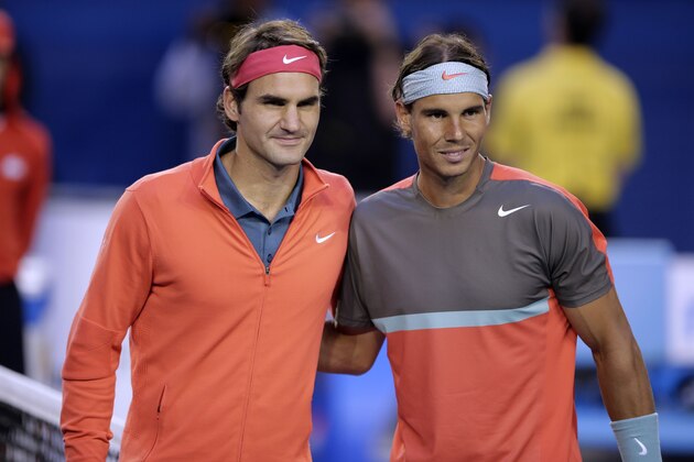 Rafael Nadal of Spain, right, and  Roger Federer of Switzerland pose at the net before their semifinal at the Australian Open tennis championship in Melbourne, Australia, Friday, Jan. 24, 2014.(AP Photo/Rick Rycroft)