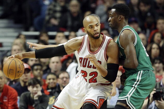 Chicago Bulls forward Taj Gibson (22) drives against Boston Celtics forward Jeff Green (8) during the first half of an NBA basketball game in Chicago on Saturday, Jan. 3, 2015. (AP Photo/Nam Y. Huh)