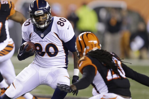 Denver Broncos tight end Julius Thomas (80) is tackled by Cincinnati Bengals free safety Reggie Nelson (20) during the first half of an NFL football game Monday, Dec. 22, 2014, in Cincinnati. (AP Photo/Michael Conroy)