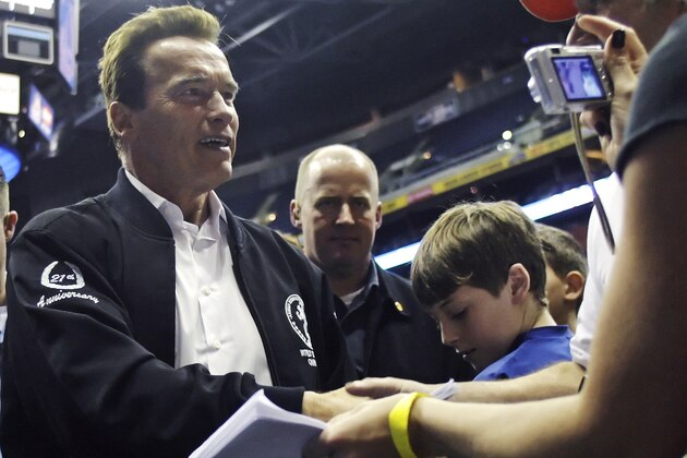 California Gov. Arnold Schwarzenegger shakes hands and signs autographs for wrestlers and their families during the Arnold Sports Festival Sunday, March 8, 2009, in Columbus, Ohio. (AP Photo/Jay LaPrete)