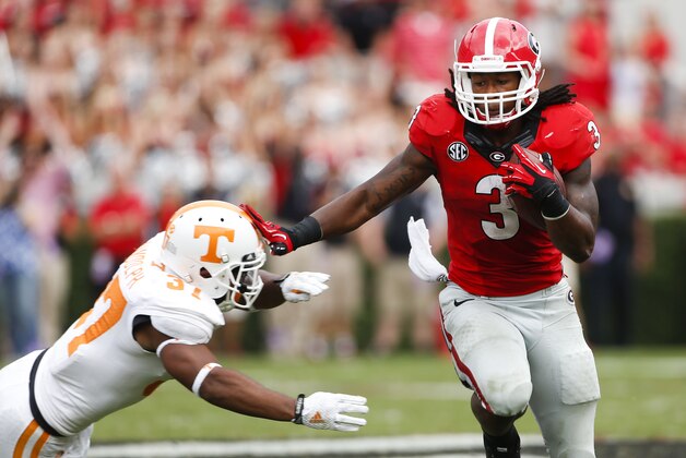 Georgia running back Todd Gurley (3) tries to break free from Tennessee defensive back Brian Randolph (37) in the second half of an NCAA college football game  Saturday, Sept. 27, 2014, in Athens, Ga. Georgia won 35-32. (AP Photo/John Bazemore)