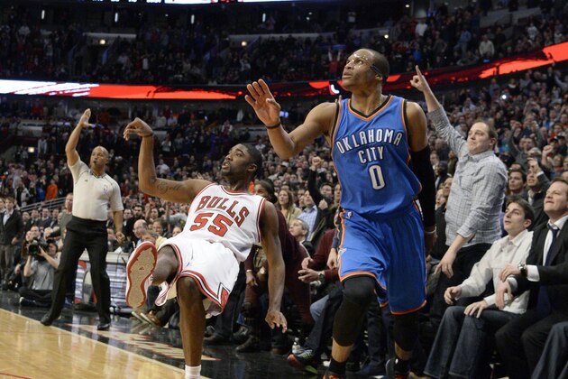 Chicago Bulls guard E'Twaun Moore (55) watches his game winning three-point shot go in as does Oklahoma City Thunder guard Russell Westbrook (0) during the second half of an NBA basketball game, in Chicago, Thursday, March 5, 2015.  The Bulls won 108-105.  (AP Photo/David Banks)