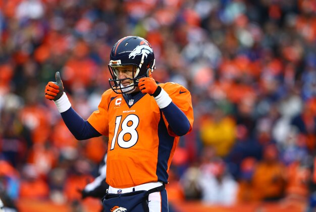 Jan 11, 2015; Denver, CO, USA; Denver Broncos quarterback Peyton Manning (18) reacts against the Indianapolis Colts in the 2014 AFC Divisional playoff football game at Sports Authority Field at Mile High. The Colts defeated the Broncos 24-13. Mandatory Credit: Mark J. Rebilas-USA TODAY Sports
