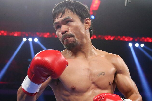 MACAU - NOVEMBER 23:  Manny Pacquiao of the Philippines punches Chris Algieri of the United States during the WBO world welterweight title at The Venetian on November 23, 2014 in Macau, Macau.  (Photo by Chris Hyde/Getty Images)