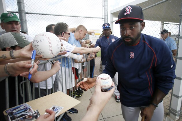 Boston Red Sox's Jackie Bradley Jr., front, and Hanley Ramirez, rear, sign autographs for fans after a workout at baseball spring training in Fort Myers Fla., Monday Feb. 23, 2015. (AP Photo/Tony Gutierrez)