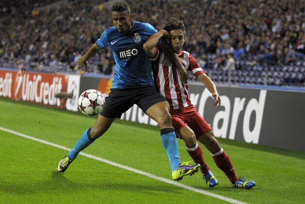PORTO, PORTUGAL - OCTOBER 1:  Oliver Torres (R) of Club Atletico de Madrid challenges Danilo of FC Porto during the UEFA Champions League group stage match between FC Porto and Club Atletico de Madrid held on October 1, 2013 at the Estadio do Dragao, in Porto, Portugal. (Photo by Miguel Riopa/EuroFootball/Getty Images)