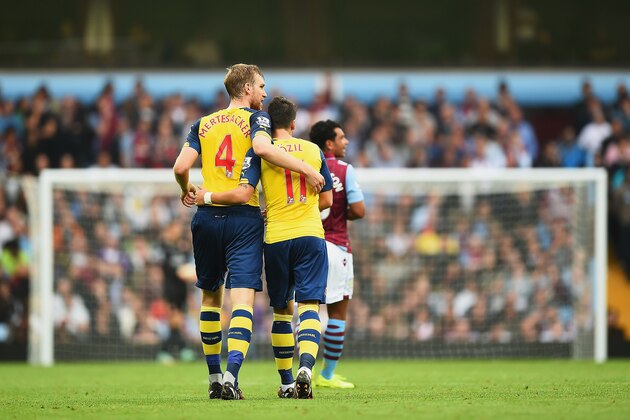 BIRMINGHAM, ENGLAND - SEPTEMBER 20:  Mesut Oezil (R) of Arsenal celebrates with Per Mertesacker of Arsenal during the Barclays Premier League match between Aston Villa and Arsenal at Villa Park on September 20, 2014 in Birmingham, England.  (Photo by Laurence Griffiths/Getty Images)