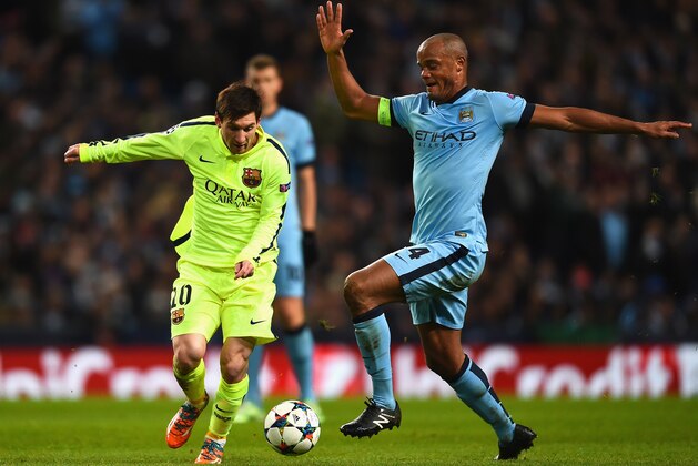 MANCHESTER, ENGLAND - FEBRUARY 24:  Vincent Kompany of Manchester City challenges Lionel Messi of Barcelona during the UEFA Champions League Round of 16 match between Manchester City and Barcelona at Etihad Stadium on February 24, 2015 in Manchester, United Kingdom.  (Photo by Laurence Griffiths/Getty Images)