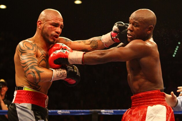 LAS VEGAS, NV - MAY 05:  (L-R) Miguel Cotto and Floyd Mayweather Jr. exchange punches during their WBA super welterweight title fight at the MGM Grand Garden Arena on May 5, 2012 in Las Vegas, Nevada.  (Photo by Al Bello/Getty Images)