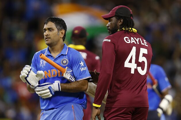 Indian captain M S Dhoni, left, is congratulated by West Indies Chris Gayle after there four wicket win in their Cricket World Cup Pool B match in Perth, Australia, Friday, March 6, 2015. (AP Photo/Theron Kirkman)