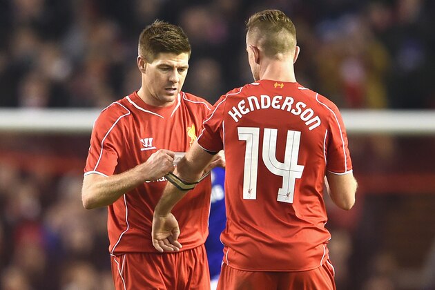 LIVERPOOL, ENGLAND - JANUARY 20:  Steven Gerrard of Liverpool hands the Captain's arm band over to Jordan Henderson of Liverpool during the Capital One Cup Semi-Final first leg match between Liverpool and Chelsea at Anfield on January 20, 2015 in Liverpool, England.  (Photo by Michael Regan/Getty Images)