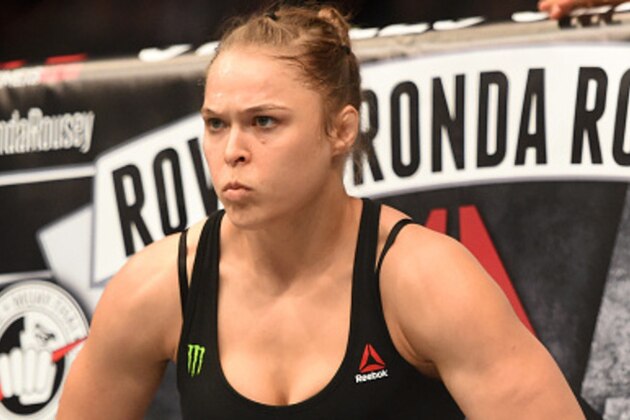 LOS ANGELES, CA - FEBRUARY 28:  Ronda Rousey enters the Octagon in her UFC women's bantamweight championship bout against Cat Zingano during the UFC 184 event at Staples Center on February 28, 2015 in Los Angeles, California.  (Photo by Harry How/Getty Images)