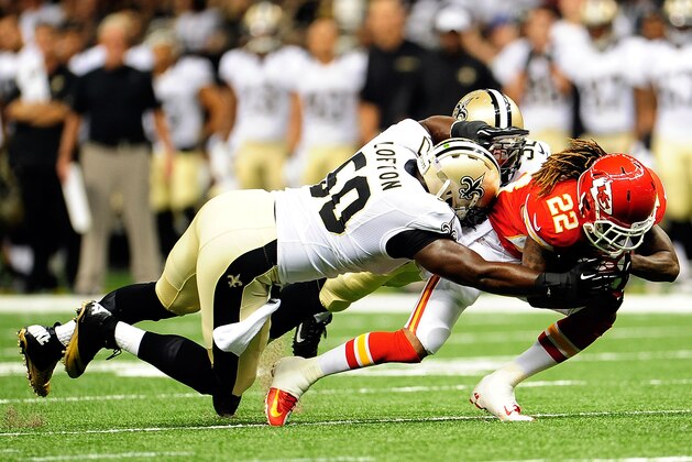 NEW ORLEANS, LA - AUGUST 09:  Dexter McCluster #22 of the Kansas City Chiefs is brought down by Curtis Lofton #50 of the New Orleans Saints during a game at the Mercedes-Benz Superdome on August 9, 2013 in New Orleans, Louisiana.  (Photo by Stacy Revere/Getty Images)