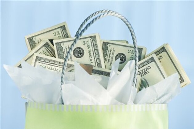 A gift bag with bank notes (Photo by: Tetra Images/AP Images)