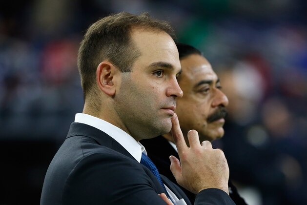 HOUSTON, TX - DECEMBER 28:  Team general manager David Caldwell (L) chats with Shahid Khan, the owner of the Jacksonville Jaguars on the field before their game against the Houston Texans at NRG Stadium on December 28, 2014 in Houston, Texas.  (Photo by Scott Halleran/Getty Images)