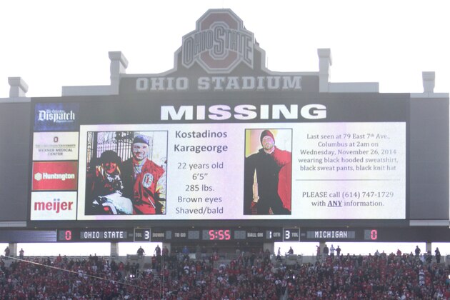 FILE - In this Nov. 29, 2014, file photo, a police poster showing Kosta Karageorge, an Ohio State player who has been missing since earlier in the week, is displayed on the large video board at the south end of the field before the Ohio State NCAA college football game against Michigan in Columbus, Ohio. Police tell media outlets Sunday, Nov. 30, 2014, they believe a body found near the campus was that of 22-year-old Karageorge. (AP Photo/Jay LaPrete, File)
