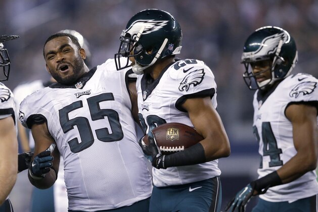 Philadelphia Eagles' Brandon Graham (55) celebrates with Cary Williams, center, after Williams intercepted a Dallas Cowboys' Tony Romo pass during the second half of an NFL football game, Thursday, Nov. 27, 2014, in Arlington, Texas. (AP Photo/Tim Sharp)